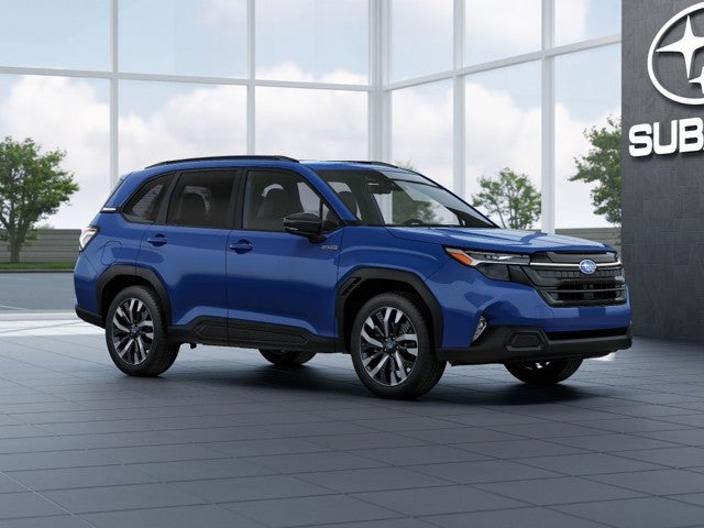 2026 Subaru FORESTER Touring Hybrid in Daybreak Blue Pearl — front three-quarter view
